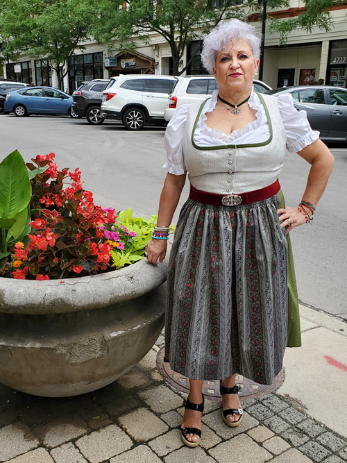 Dirndl Dress beige color top green trimming around neckline beautiful Porcelain flower painted   buttons the skirt is green and the Apron  green  striped with roses design Belt is red velvet